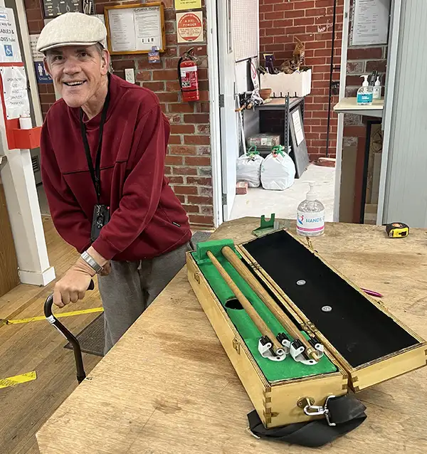 elderly man with pool cue in box