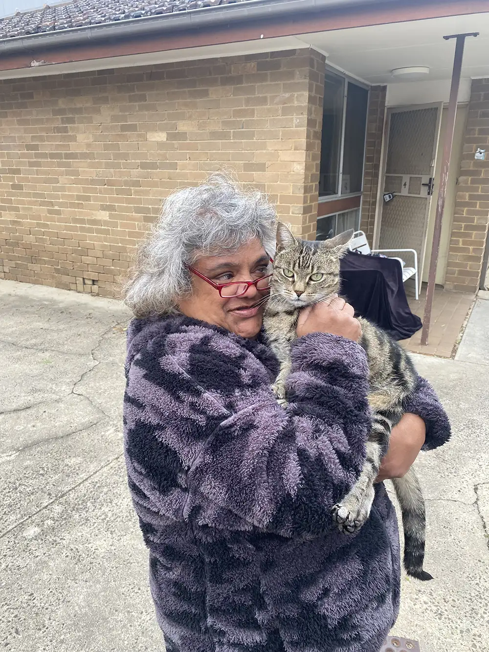 Joanne cuddling her cat
